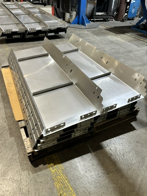 MLC Manufacturing — formed stainless steel assemblies on pallet