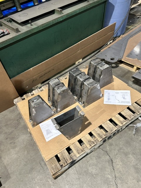 MLC Manufacturing — formed steel parts on pallet