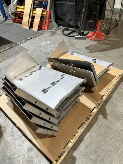 MLC Manufacturing — formed sheet metal parts on pallet