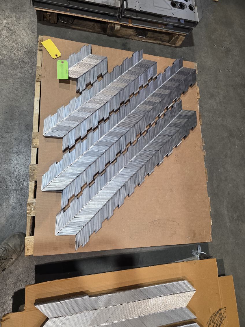 MLC Manufacturing — stacked formed angle brackets on pallet